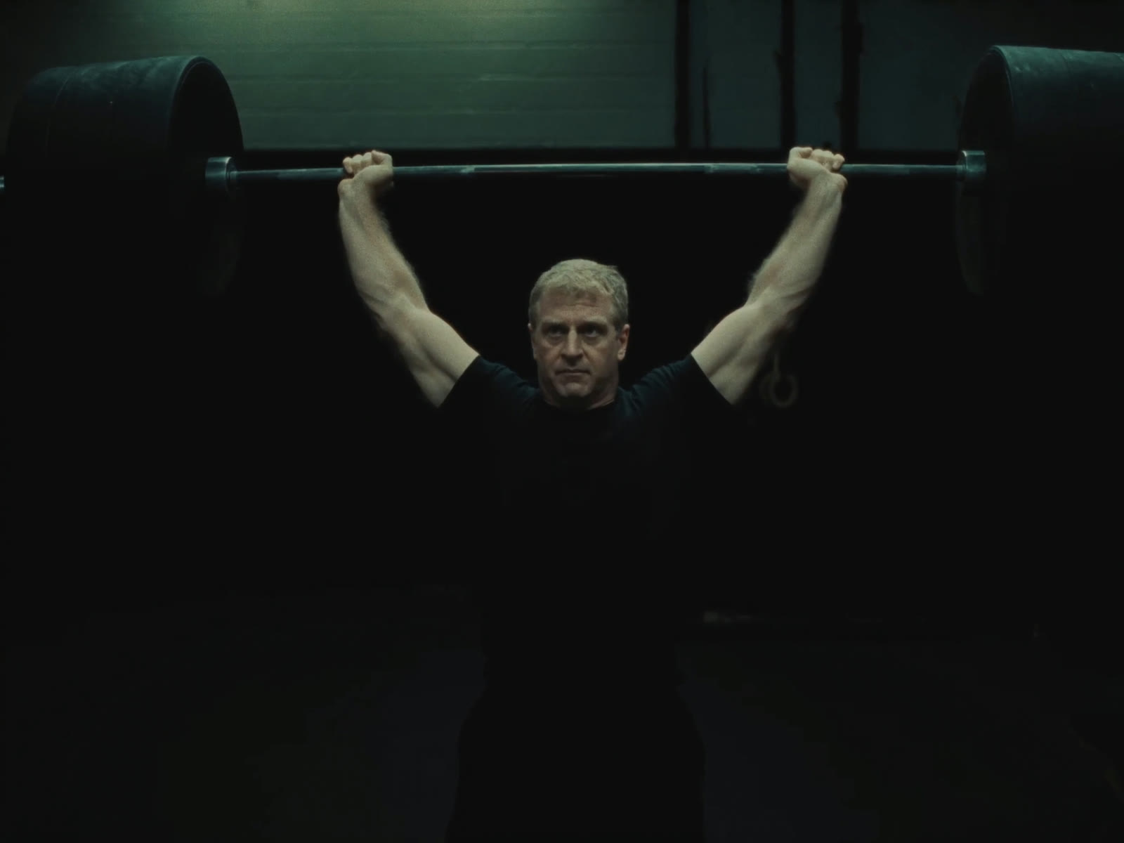 Man pressing a barbell overhead
