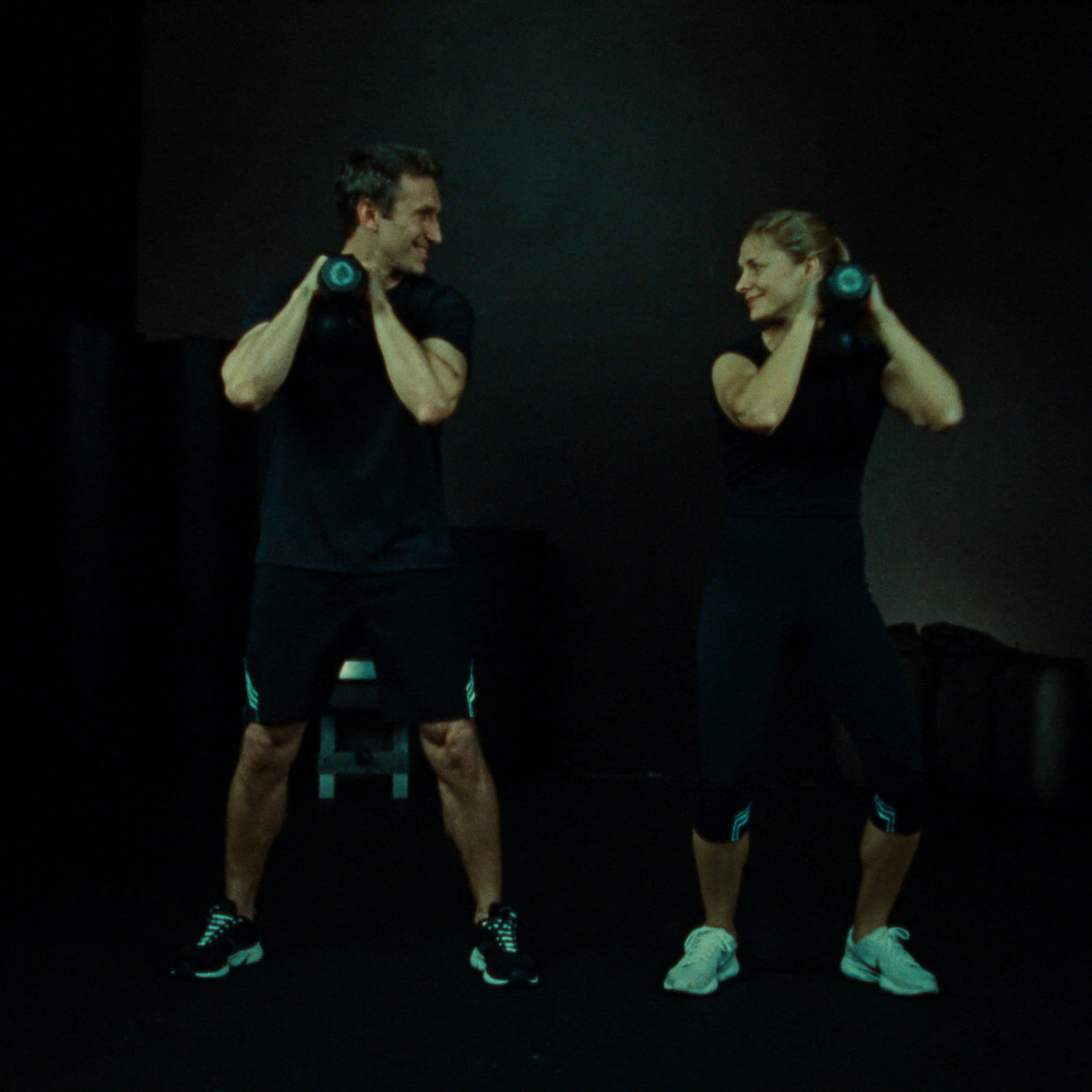 Man and woman training together on the bench press